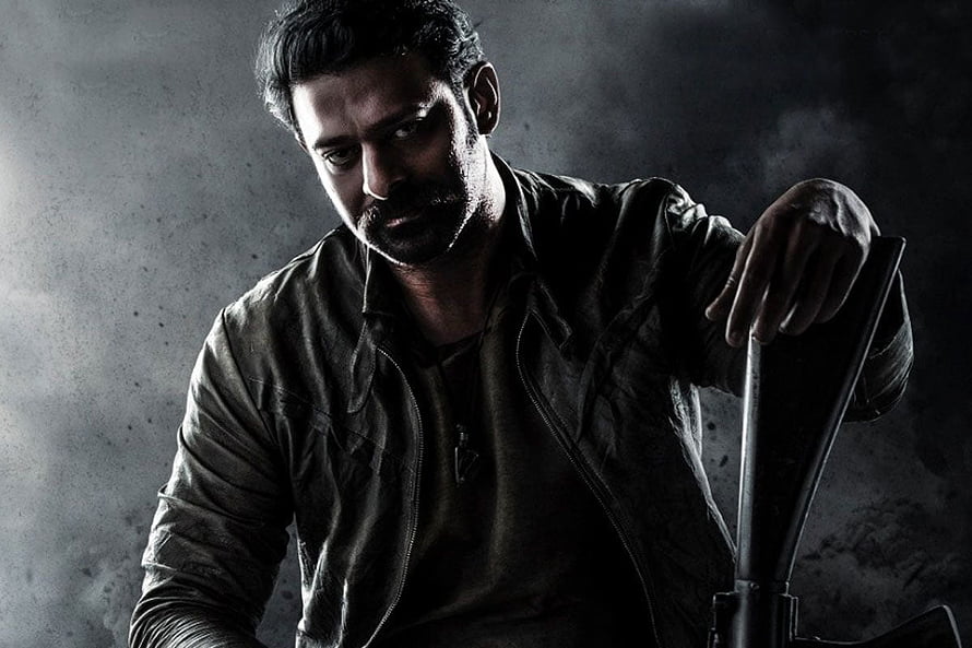 Prabhas in Salaar promotional portrait with dark leather jacket and intense expression HD wallpaper