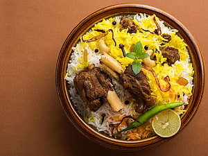 Traditional Mutton Biryani with Saffron Rice, Nuts, and Fresh Mint Garnish HD wallpaper