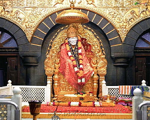 Shirdi Sai Baba Temple Murti Adorned With Marigold Garland and Red Silk Garments HD wallpaper