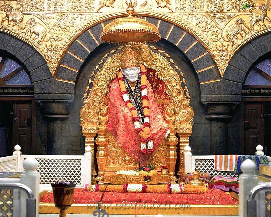 Shirdi Sai Baba Temple Murti Adorned With Marigold Garland and Red Silk Garments HD wallpaper