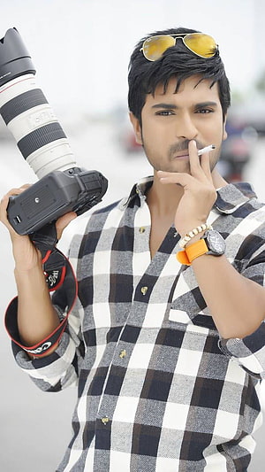 Ram Charan Teja Holding Canon Camera With Sunglasses And Orange Watch HD phone wallpaper