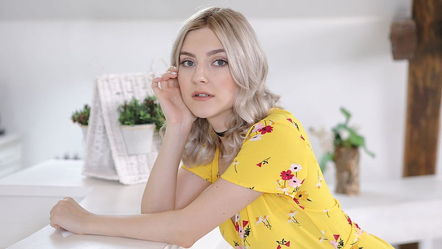 Eva Elfie in a Yellow Floral Dress Leaning on a White Table HD wallpaper