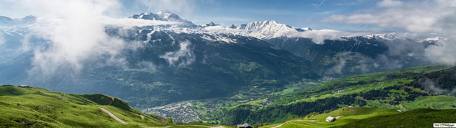 Panoramic Alpine Valley with Snow-Capped Peaks and Lush Green Hills HD wallpaper