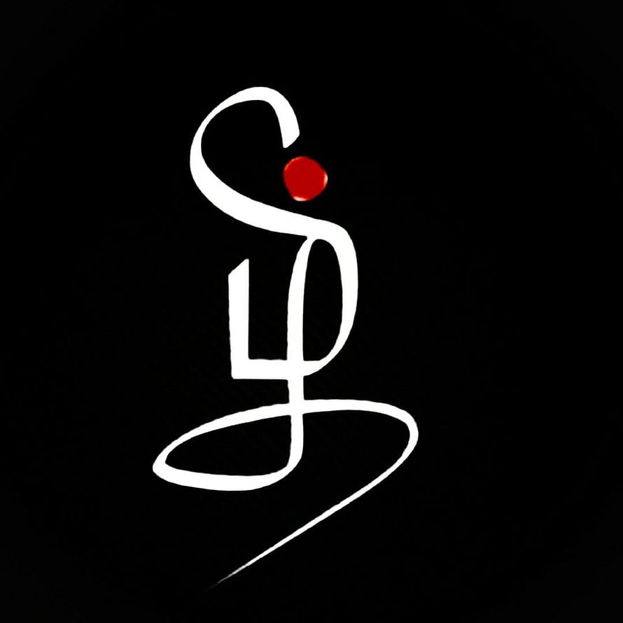 Minimalist Tamil Script Calligraphy with Red Accent on Black Background HD phone wallpaper
