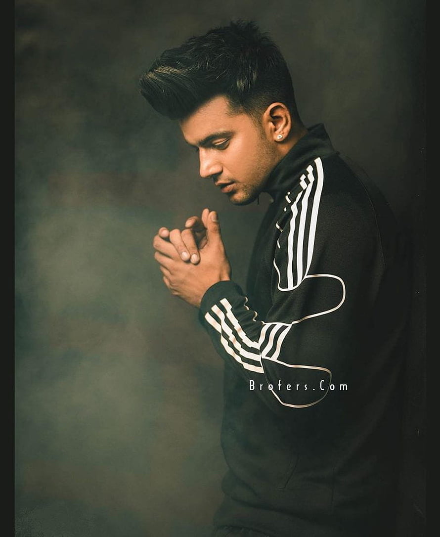 Jass Manak in a black track jacket with hands clasped in a moody studio portrait HD phone wallpaper