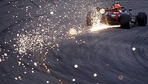 Red Bull Racing Formula 1 car drifting through a corner with a dramatic trail of bright sparks on the asphalt HD wallpaper