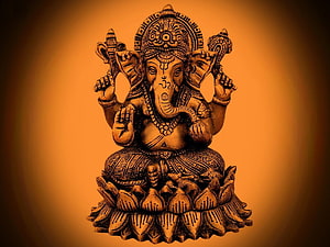 Ganesha seated on a lotus throne with four arms and ornate crown in warm golden tones HD wallpaper