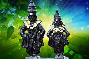 Vitthal and Rukmini Black Stone Idols with Jasmine Garlands on Vibrant Green Background HD wallpaper