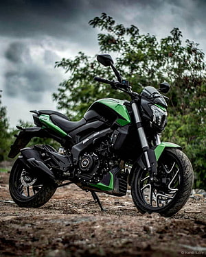 Kawasaki Z400 Green and Black Motorcycle Parked on Gravel Under Stormy Sky HD phone wallpaper
