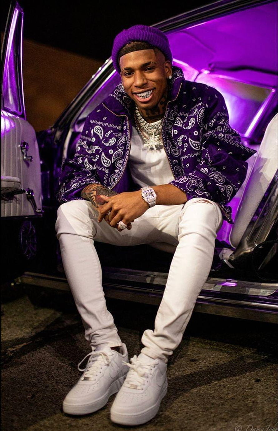 Nle Choppa in purple bandana jacket and white outfit sitting on a car step with neon lighting HD phone wallpaper