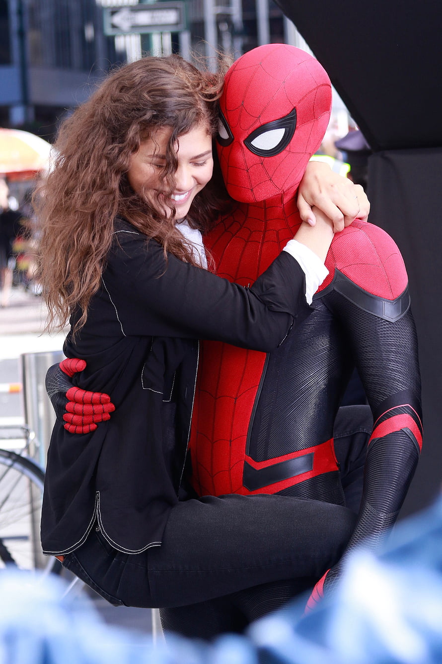 Zendaya and Spider-Man in a warm embrace during a public promotional event HD phone wallpaper