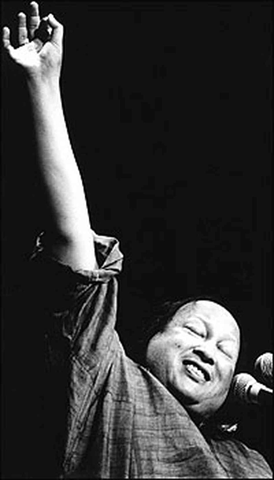 Nusrat Fateh Ali Khan performing live with raised arm and microphone HD phone wallpaper