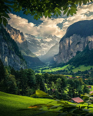 Lauterbrunnen Valley in Switzerland with Snow-Capped Alpine Peaks and Lush Green Meadows HD phone wallpaper