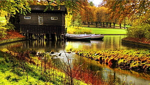 Autumnal Riverside Scene With Wooden Boathouse And Moored Boats HD wallpaper