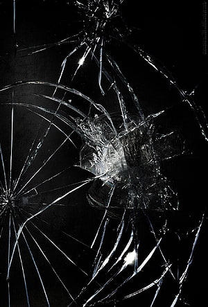 Shattered Glass Texture with Radiating Cracks on Black Background HD phone wallpaper