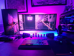 Vibrant RGB Gaming Setup with Curved Monitor and Mechanical Keyboard HD wallpaper