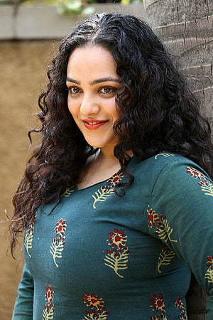 Nithya Menon in a green embroidered kurta with long curly hair HD phone wallpaper