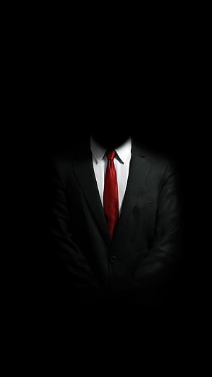 Mysterious Faceless Figure in Black Suit with Red Tie Against Dark Background HD phone wallpaper