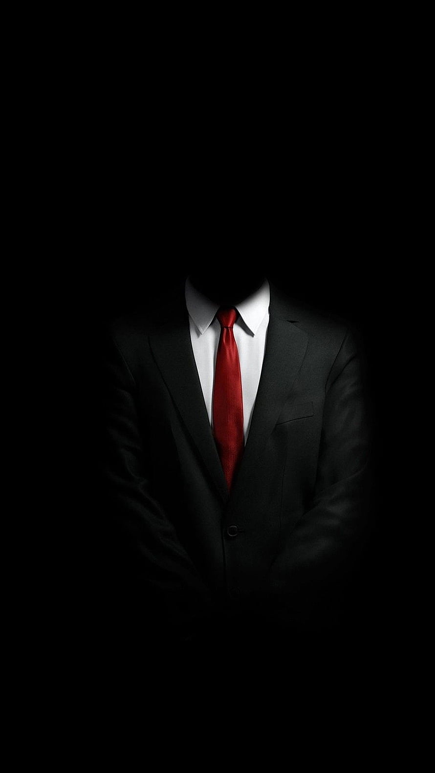 Mysterious Faceless Figure in Black Suit with Red Tie Against Dark Background HD phone wallpaper