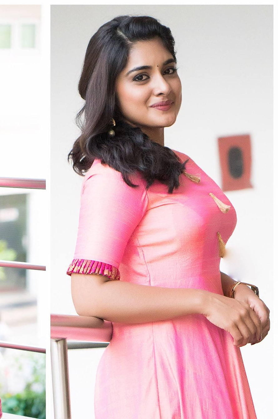 Nivetha Thomas in a vibrant pink traditional dress with gold accents and elegant jewelry HD phone wallpaper