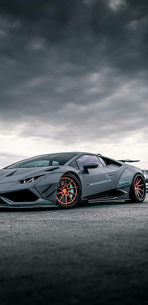 Modified Lamborghini Huracan with Orange Wheels Under Dramatic Stormy Sky HD phone wallpaper