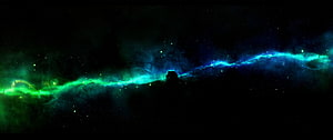 Vivid Green and Blue Aurora Borealis Over a Dark Silhouetted Landscape HD wallpaper