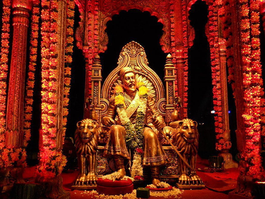 Chhatrapati Shivaji Maharaj Rajyabhishek Statue with Lion Guardians and Floral Decorations HD wallpaper