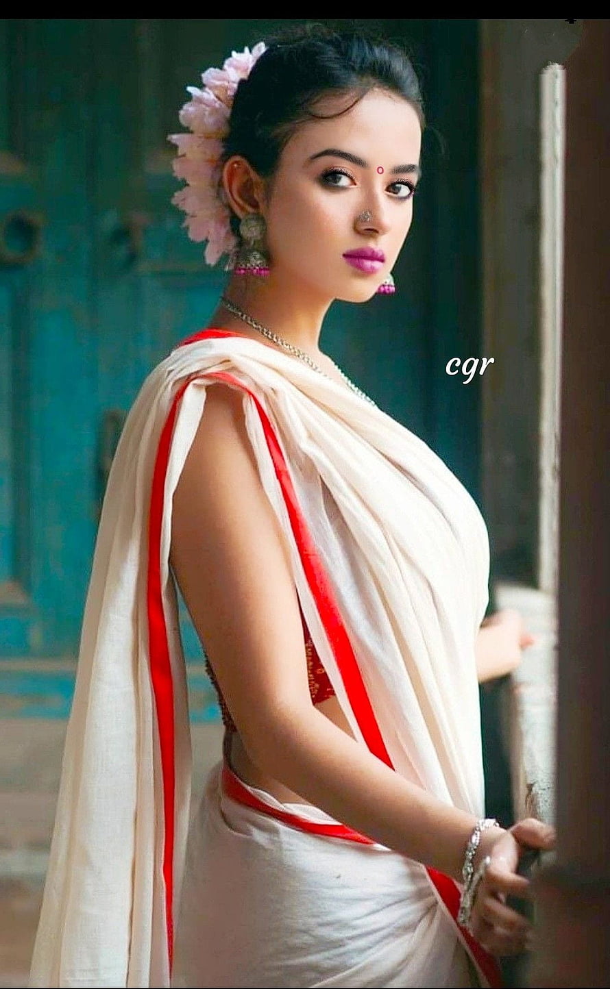 Elegant Woman in White Saree with Red Border and Floral Hairpiece HD phone wallpaper