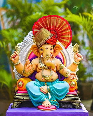 Ornate Ganesha Murti Seated on a Decorative Throne with Red Fan and Gold Jewelry HD phone wallpaper