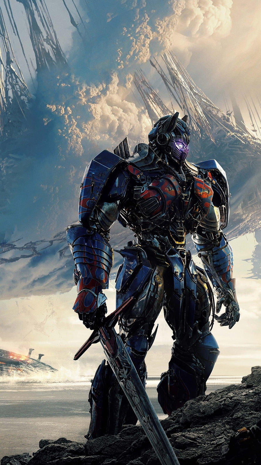 Optimus Prime in Heavy Battle Armor Standing on Rocky Terrain with Giant Sword HD phone wallpaper