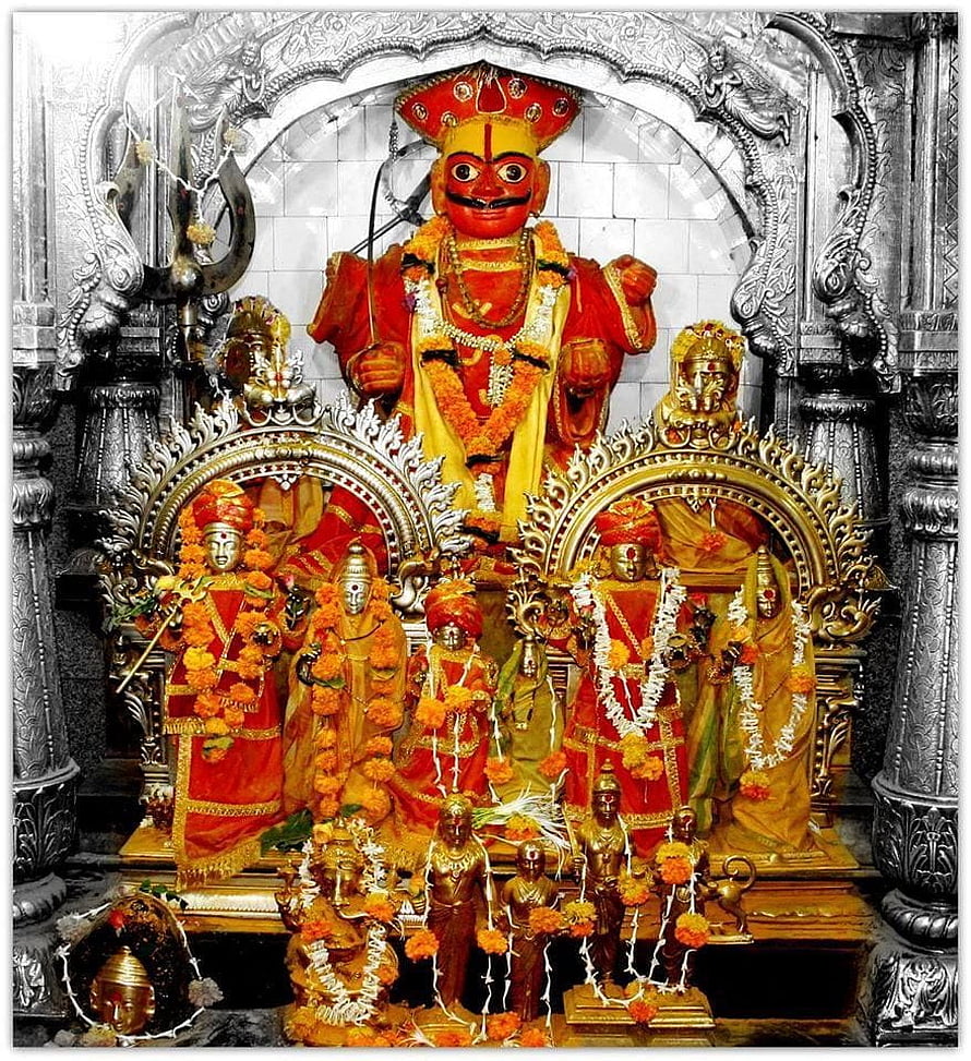 Khandoba Deity at Jejuri Temple with Ornate Silver Shrine and Marigold Garlands HD phone wallpaper