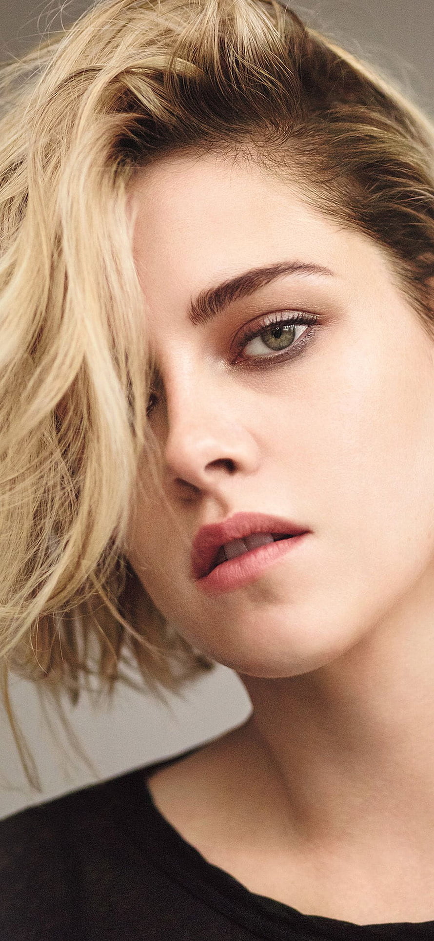 Kristen Stewart Close-Up Portrait with Short Blonde Hair and Intense Green Eyes HD phone wallpaper