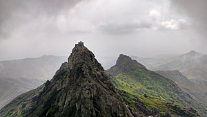 Girnar Mountain Peak with Temple Under Dramatic Cloudy Skies HD wallpaper