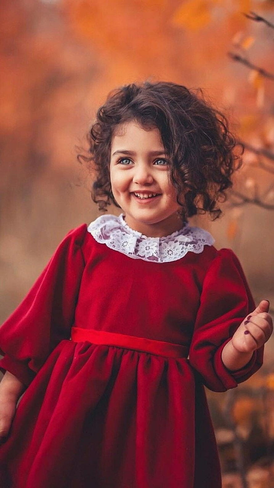 Anahita in a red velvet dress with a white lace collar against a warm autumn background HD phone wallpaper