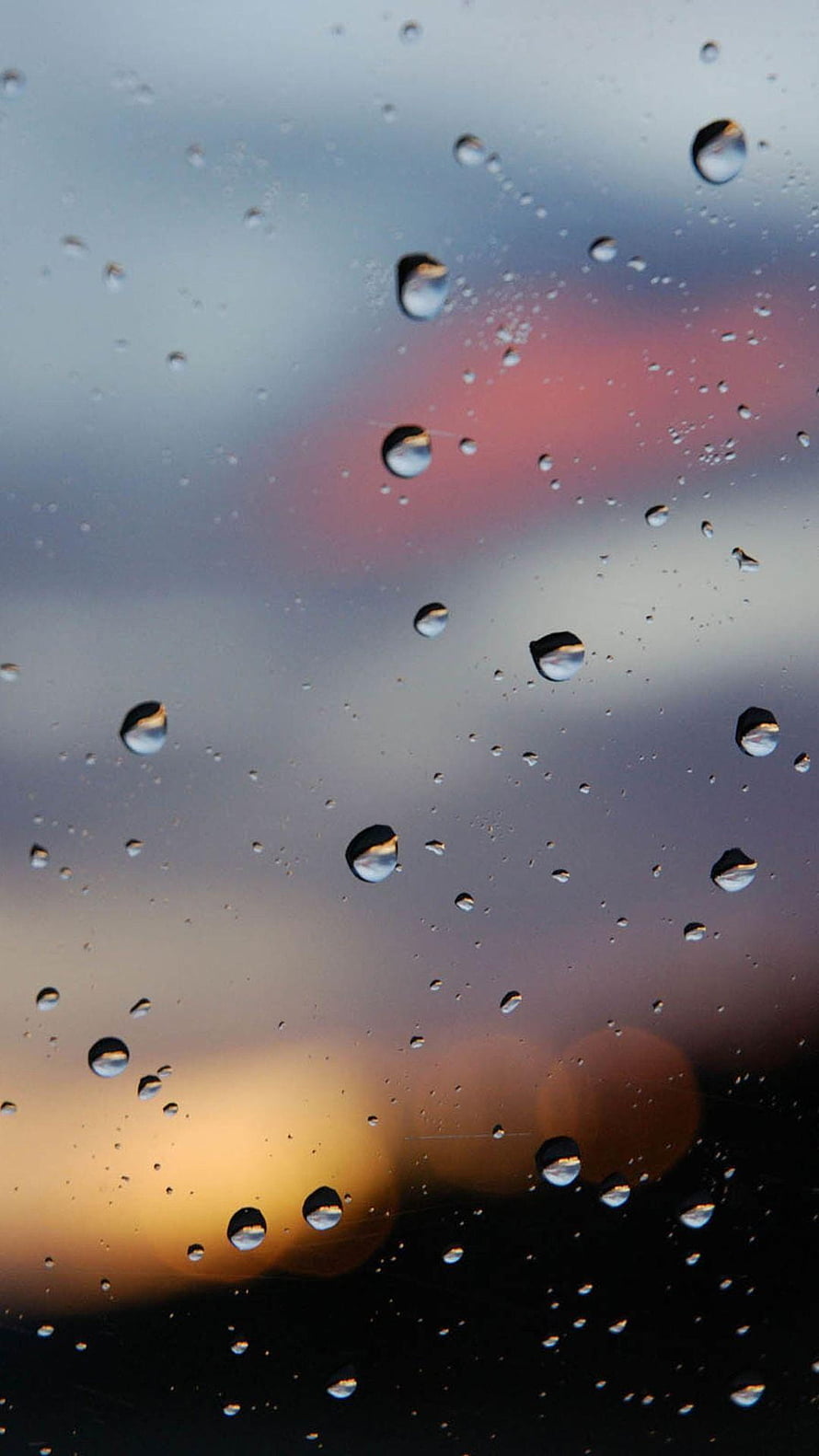 Raindrops on a Window Pane with a Blurred Sunset Sky and Bokeh Lights HD phone wallpaper