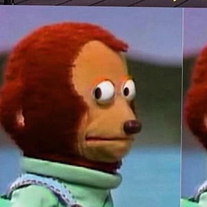 Close-up of a red-haired puppet character with a surprised expression wearing a green turtleneck HD phone wallpaper