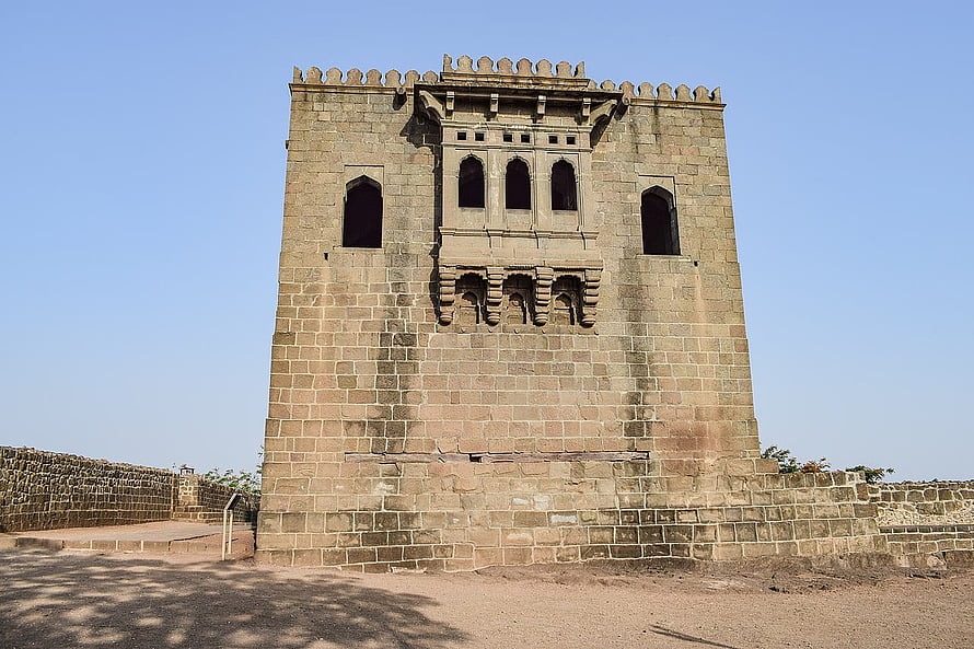 Shivneri Fort Historic Stone Tower and Crenellated Battlements Under Clear Blue Sky HD wallpaper