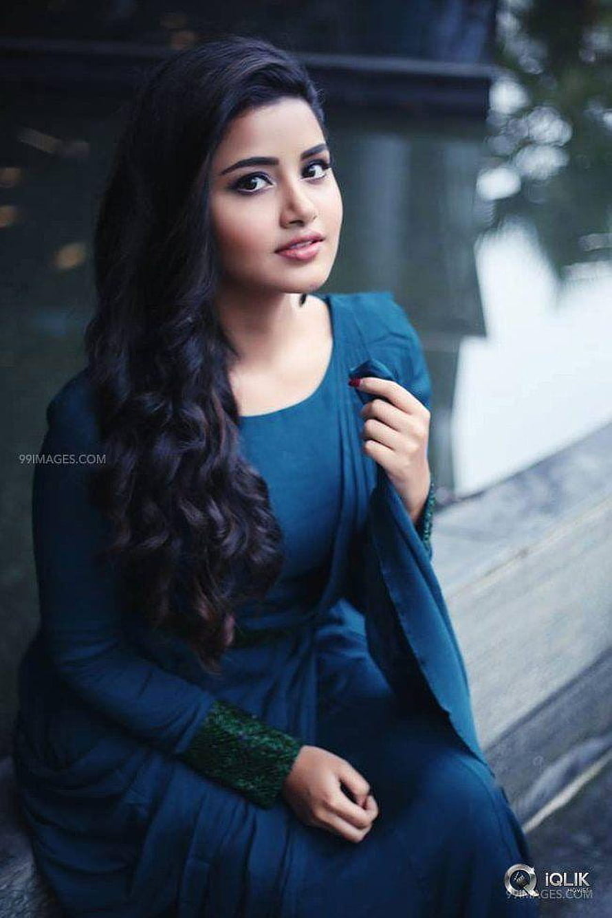 Anupama Parameswaran in a teal dress with long wavy hair HD phone wallpaper