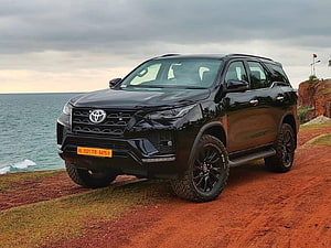 Black 2021 Toyota Fortuner SUV Parked on Coastal Cliff with Ocean View HD wallpaper