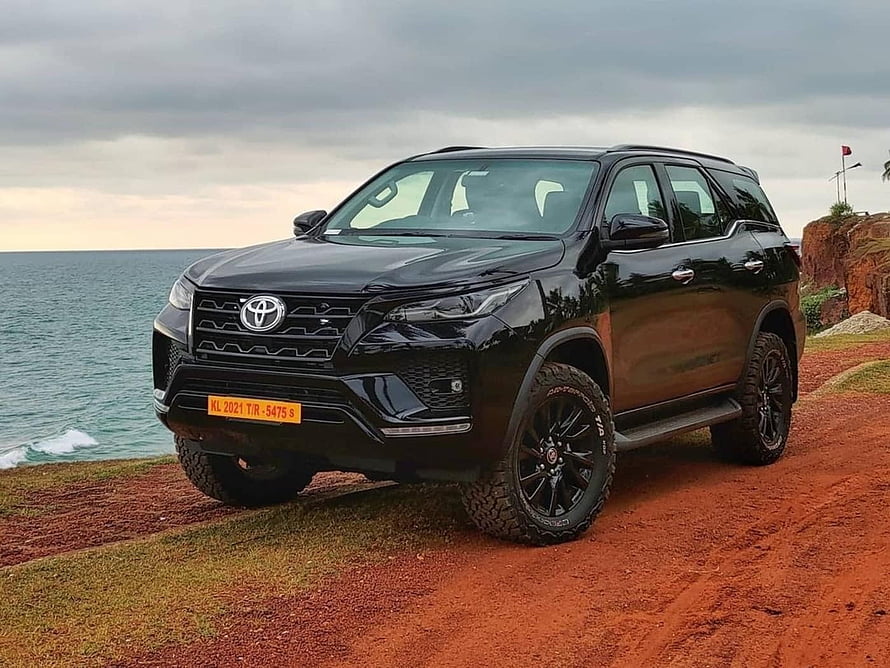 Black 2021 Toyota Fortuner SUV Parked on Coastal Cliff with Ocean View HD wallpaper