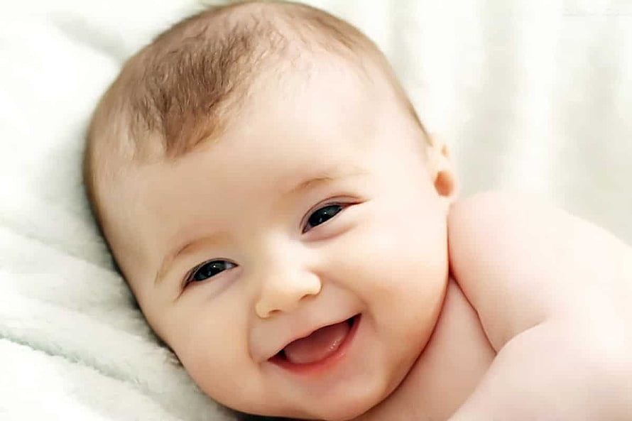 Smiling Baby Boy Lying on Soft White Blanket HD wallpaper