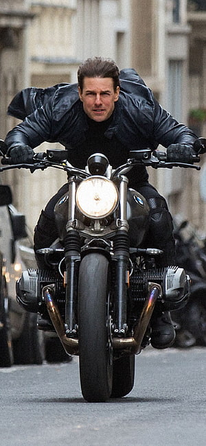 Tom Cruise as Ethan Hunt riding a BMW motorcycle in Mission Impossible Fallout HD phone wallpaper