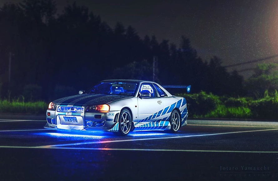 Nissan Skyline GT-R R34 with Blue Underglow on Night Road HD wallpaper