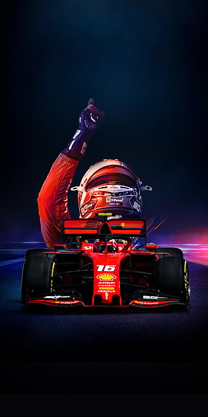 Charles Leclerc Ferrari F1 Car with Helmet and Victory Gesture on Dark Track HD phone wallpaper