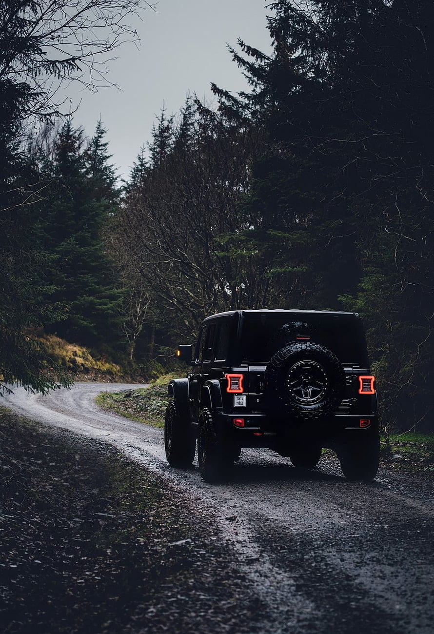 Black Jeep Wrangler on a Wet Forest Road with Off-Road Tires and Rear Spare HD phone wallpaper