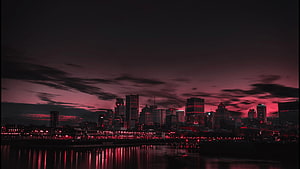 Moody Red Tinted City Skyline at Night with Water Reflections HD wallpaper