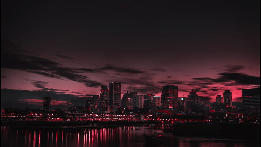 Moody Red Tinted City Skyline at Night with Water Reflections HD wallpaper