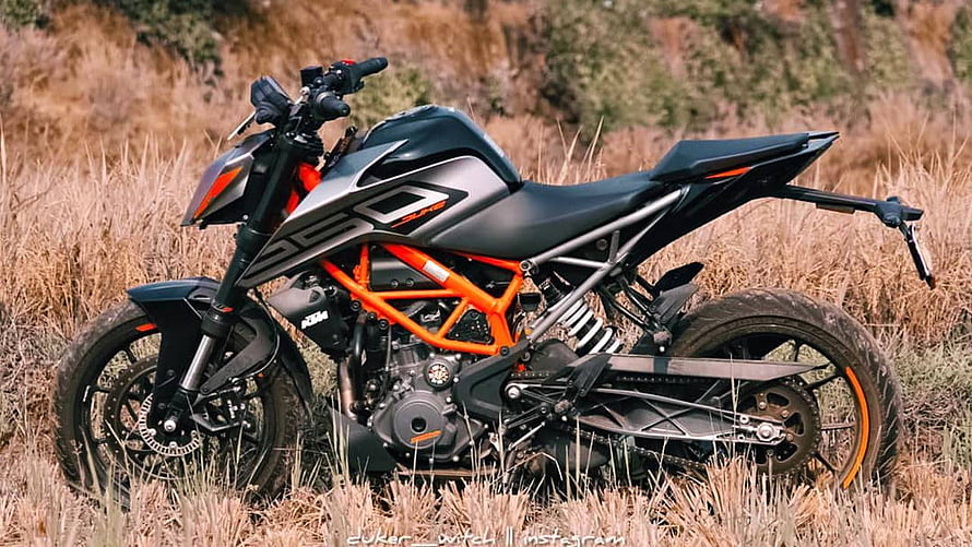 KTM Duke 250 motorcycle with orange frame parked in dry grass field HD wallpaper