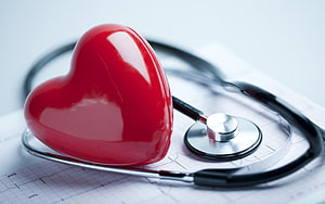 Red Heart Model and Stethoscope on ECG Paper for Cardiology Concept HD wallpaper
