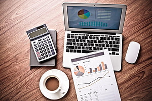 Business Accounting Workspace With Laptop, Calculator, and Financial Reports HD wallpaper